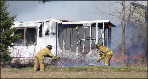 Wind-blown fire burns rural buildings